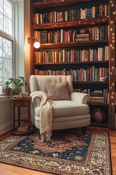 a chair in front of a book shelf with many books on it and a rug