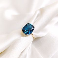 This stunning ring is set in 14k Solid Yellow Gold with Natural London Blue Topaz with utmost precision. It is a unique statement gemstone ring for nearly every occasion and is completely hassle-free jewelry. ITEM DETAILS: * GEM: London Blue Topaz * GEM SIZE: 10X12mm * GEM SHAPE: Cushion cut * GEM WEIGHT: 5.96 carats * Gold Purity: 14KT * Gold Weight: 1.73 gram * Total Weight of the Ring: 2.92 gram The Gold purity is guaranteed and it comes with authentic 14KT gold hallmark. Since my items are h London Blue Engagement Ring, Cushion Cut Topaz Ring Gemstone For Gift, Gift Cushion Cut Blue Topaz Ring, Cushion Cut Blue Rings For Gifts, Gift Blue Topaz Cushion Cut Ring, Blue Cushion Cut Topaz Ring Gift, Cushion Cut Topaz Ring With Accent Stones As Gift, Cushion Cut Topaz Ring With Prong Setting As Gift, London Blue Topaz Jewelry