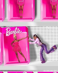 barbie dolls on display in pink boxes with the name barbie written on one side and another