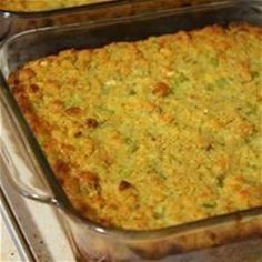 a casserole dish with broccoli and cheese in it sitting on a stove