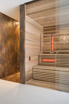 an indoor sauna is shown in this modern bathroom with wooden walls and flooring