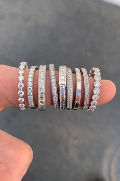 a person is holding five different rings on their finger and they are all stacked together