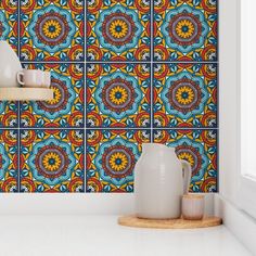 a colorful wallpaper with an intricate design on the side and shelves in front of it