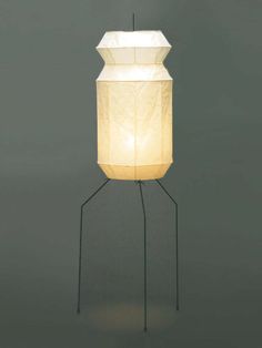 a lamp that is sitting on top of a metal stand with a light bulb in the middle