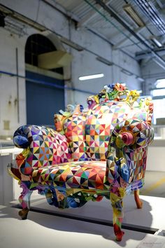 a brightly colored chair sitting on top of a white floor