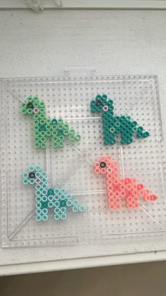 three lego animals sitting on top of a plastic tray next to each other in front of a white wall