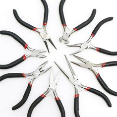 a group of black and red pliers arranged in a circle on a white surface