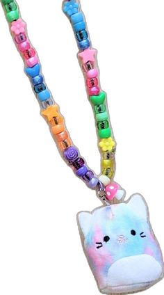 an animal shaped key chain with colorful beads on it's end and a cat face in the middle