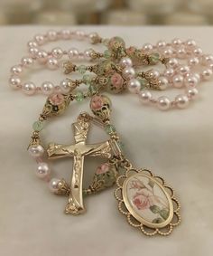 the rosary is adorned with pearls and flowers