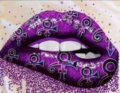 a purple lips with white and black designs on the lip, surrounded by sparkles