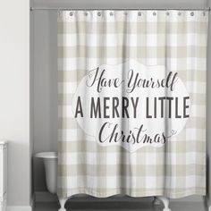 a merry little christmas shower curtain hanging in a bathroom