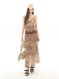 Embrace your wild side with our Leopard Print Sheer Maxi Dress – a perfect fusion of edgy allure and sheer elegance. This striking piece features a boldly patterned sheer overlay that falls gracefully over a sleek, form-fitting tube top design. The lightweight, flowy material and the sleeveless cut make it a go-to for warm weather, while also transitioning effortlessly into cooler evenings. Pair this dress with chunky boots for an urban adventure or strappy sandals for a sun-drenched day out. It Tube Top Design, Sheer Maxi Dress, Y2k Dress, Sheer Overlay, Casual Evening, Chunky Boots, Top Design, Tube Top, Warm Weather