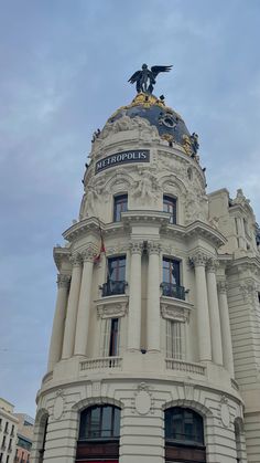 an ornate building with a statue on top