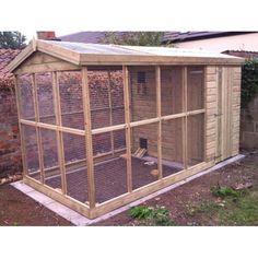 a large wooden chicken coop in the back yard with an enclosed area for chickens to sit inside