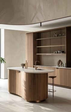 a modern kitchen with wooden cabinets and white counter tops, along with an island in the middle