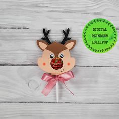 a reindeer lollipop on a stick with a green circle around it and the words digital reindeer lollipop