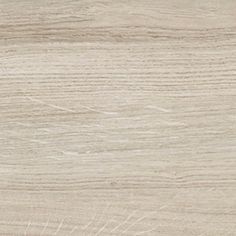 a close up view of a wood grain textured surface with light brown and white tones