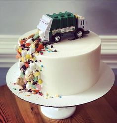 a white cake with a green truck on top