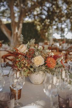 an image of a table setting with flowers and wine glasses on the table for guests to enjoy