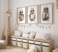 three owls are hanging on the wall above a bench with storage bins underneath them