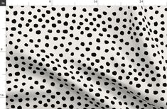 black and white polka dot print fabric, with the ruler showing it's length