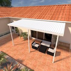 a covered patio area with furniture on the floor and an orange tiled roof above it