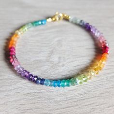 This rainbow bracelet has a great variety of natural gemstones. They are : Aquamarine, raw Ruby, Garnet, Amethyst, Iolite, Peridot, Citrine, Carnelian, Tourmaline, Apatite , blue sapphire rock Quartz, Tanzanite and emerald A gorgeous fusion of colors in this multi stone precious  bracelet. A riot of vivid  colors  in ombre design I chose and  lined the gemstones to obtain this unique shaded colorful precious bracelet. It will be beautiful alone or together with other gemstones stacking bracelets The gemstone beads are strung on the highest quality jewelery strand  beading wire and the bracelet closes with a gold filled  spring ring clasp All the gemstones are aproximately 3-4     mm - approximately The length of the bracelet is 18,00 cm   inch  7.08   You will receive the exact bracelet in Rainbow Natural Stones Beaded Bracelets For Jewelry Making, Rainbow Gemstone Beads Bracelets For Jewelry Making, Rainbow Gemstone Beads Bracelets For Healing, Rainbow Crystal Bracelet With Natural Stones For Healing, Multicolor Faceted Rondelle Bracelets, Spiritual Rainbow Bracelets For Jewelry Making, Multicolor Gemstone Rondelle Bracelets, Rainbow Gemstone Beads Bracelet For Healing, Rainbow Crystal Bracelet With Natural Stones And Round Beads