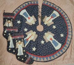 an embroidered piece of cloth with angels and stars on it