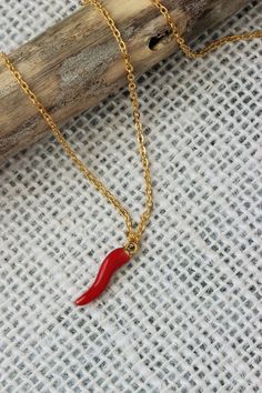 This simple boho necklace was made of red enamel metal horn pendant and gold tone stainless steel cable chain with gold tone lobster claw. The chain is from lead free & nickel free metal. The red horn charm is a symbol of hope and good luck. It is said to repel against evil eye and promote good fortune! So let this necklace bring a great luck to you or to the one you want to give as a gift! Perfect for everyday wear or an unique gift for someone special! The length of necklace is about 46 cm or Dainty Red Necklace With Lobster Clasp, Red Chain Charm Necklace For Gift, Red Pendant Chain Necklace With Clavicle Chain, Red Chain Necklace With Lobster Clasp As Gift, Red Clavicle Chain Pendant Necklace, Gift Red Chain Necklace With Gold Chain, Red Gold Chain Necklace For Gifting, Gift Red Gold Chain Necklace, Handmade Red Chain Necklace As Gift