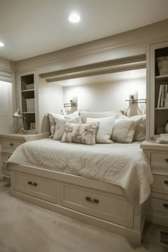 a large bed sitting in the middle of a bedroom next to a book shelf filled with books