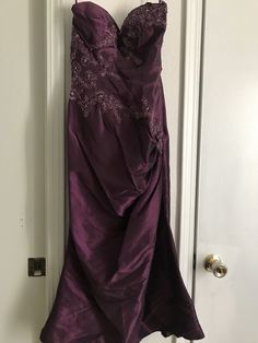 a purple dress hanging on a door