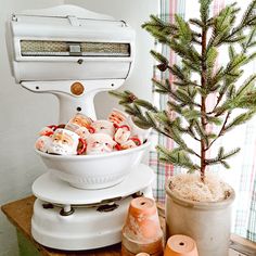 an old fashioned mixer is used as a christmas tree stand