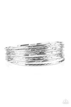 Featuring smooth, serrated, and pinched finishes, mismatched silver bangles stack across the wrist for a bold industrial look. Urban Sprawl, Jewelry Bracelets Silver, Stacked Bangles, Paparazzi Accessories, Silver Box, Silver Bangle Bracelets, Silver Bangle, Paparazzi Jewelry, One Set