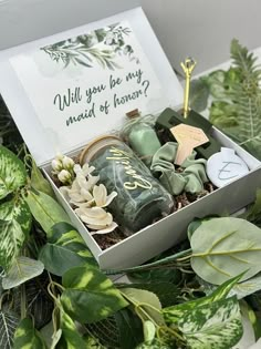 a box filled with lots of green plants next to a sign that says will you be my maid of honor?