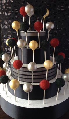 a multi layer cake with white, black and red decorations