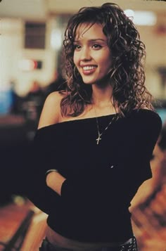 a young woman with curly hair and black top