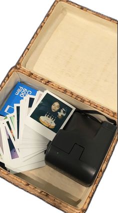 an open suitcase with some cards and a printer in it