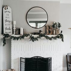 a living room filled with furniture and a fire place covered in greenery next to a fireplace