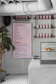 a counter with some food on it next to a sign that says coffee & tea