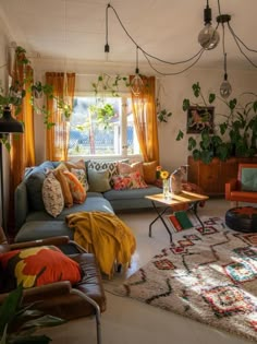 a living room filled with lots of furniture and plants