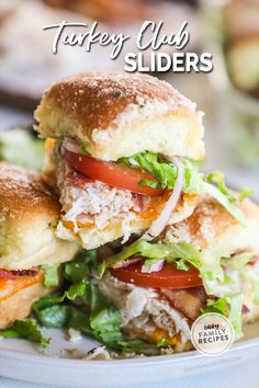 two turkey club sliders stacked on top of each other with lettuce and tomatoes