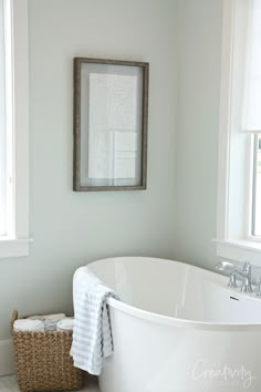 a white bath tub sitting next to a window