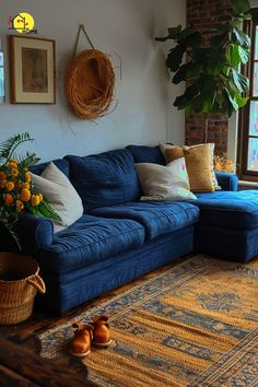 a living room with blue couches and rugs on the floor next to a window