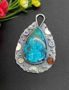 "High Grade Chrysocolla with Carnelian Gemstone pendant Hand-made Sterling Silver 925. Stones used: Chrysocolla, Carnelian, Amethyst, Blue Topaz, Peridot Height - 2 3/8\" (with bail), Width - 1 1/2\" Unique Handcrafted One-of a-kind Design Pendant Each Piece of Jewelry in my Collection is Absolutely One of a Kind! When you start wearing a piece of my jewelry you will fall in love with it more and more each day and feel that good Energy and Love that I pass into it while creating this piece of Ar Multicolor Cabochon Gemstones In Sterling Silver, Artisan Sterling Silver Cabochon Gemstones, Large Chrysocolla Pendant Jewelry, Cabochon Pendant Gemstones For Jewelry Making, Design Statement, Statement Pendant, Unique Gemstones, Good Energy, My Collection