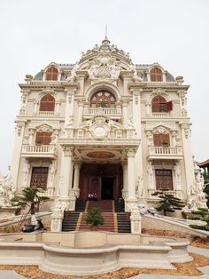 a large white building with stairs leading up to it