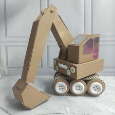 a cardboard construction vehicle sitting on top of a table