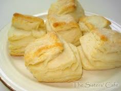 a white plate topped with biscuits on top of a table