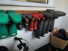 several pairs of rain boots lined up on a wall