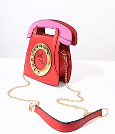 Step back in time! Made from a beautiful red leatherette, this stylish handbag is designed to resemble a retro rotary phone, complete with a metallic gold dial that adds a touch of vintage charm. And what's even more adorable? The words "Call Me..." right in the center of the dial, inviting conversations and connections wherever you go. With its top zipper closure, your belongings will stay secure as you strut through town or dance the night away. Plus, say goodbye to shoulder strain because thi Retro Shoulder Bag With Gold-tone Hardware, Retro Red Party Bag, Red Retro Party Bag, Shoulder Strain, Rotary Phone, No Strings Attached, Step Back, Back In Time, Vintage Charms