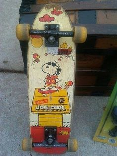 a skateboard with a snoopy dog painted on it